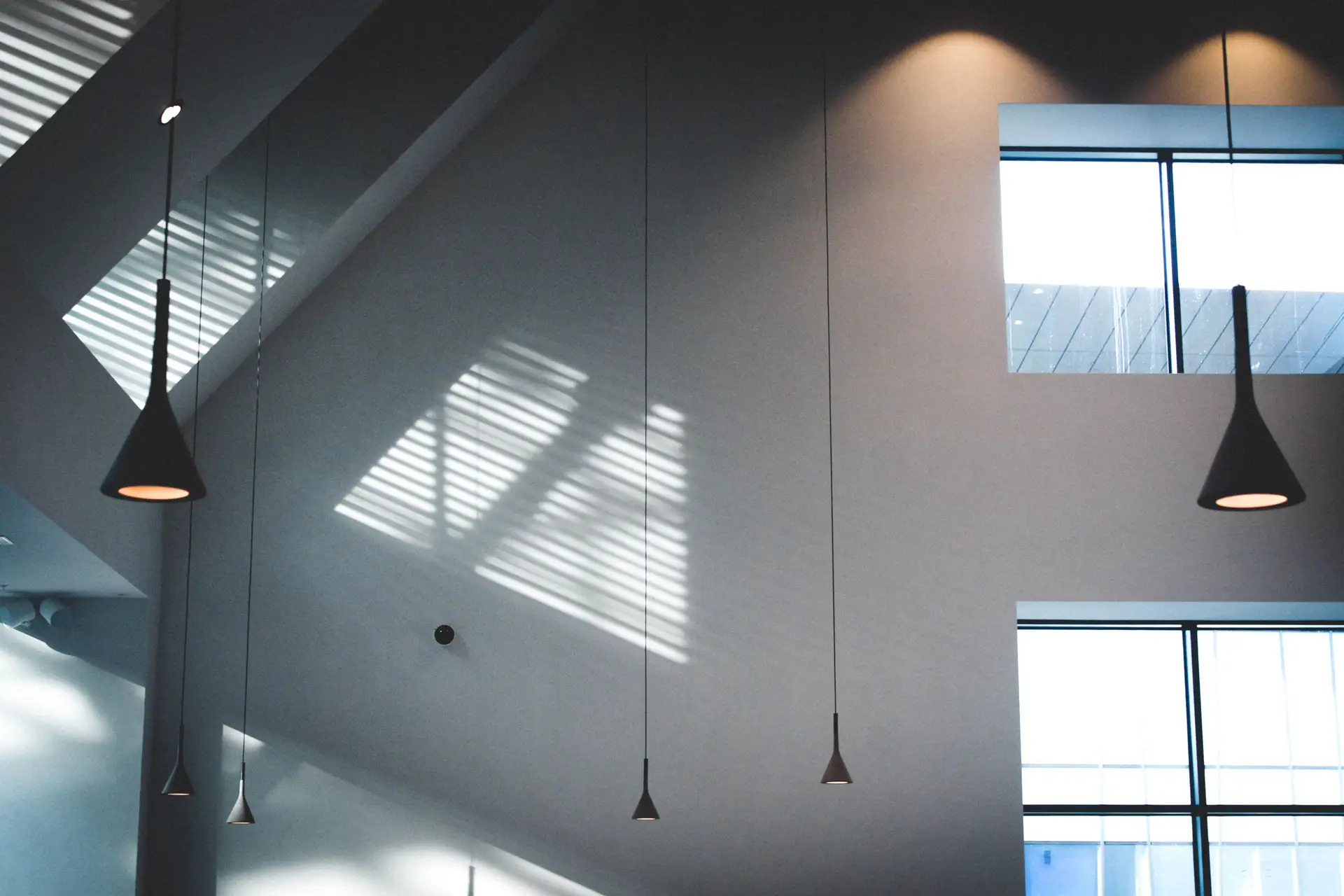 Warm pendant lighting above a contemporary interior